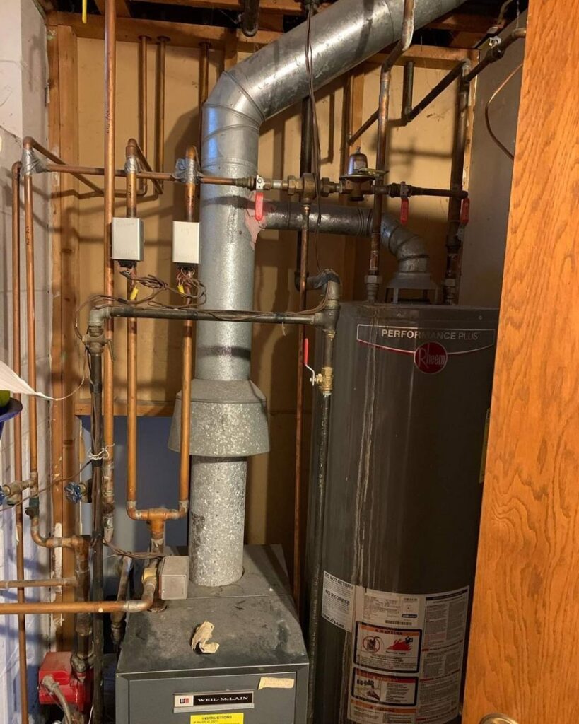 An existing Weil-McLain furnace and Rheem water heater, representing systems serviced by TruTemp Heating & Cooling LLC in Ijamsville, MD.