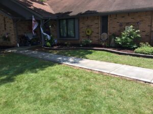 A beautifully well-maintained front yard with lush grass and mulched landscaping by Creamer Construction LLC in Saint Peters, MO.