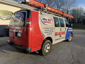 A Wes-Tech Services branded van with ladders, showcasing HVAC contractor services in Bloomington, IN.
