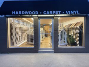 The exterior of Westcraft Flooring, with an awning clearly stating 'HARDWOOD * CARPET * VINYL' in Denver, CO.