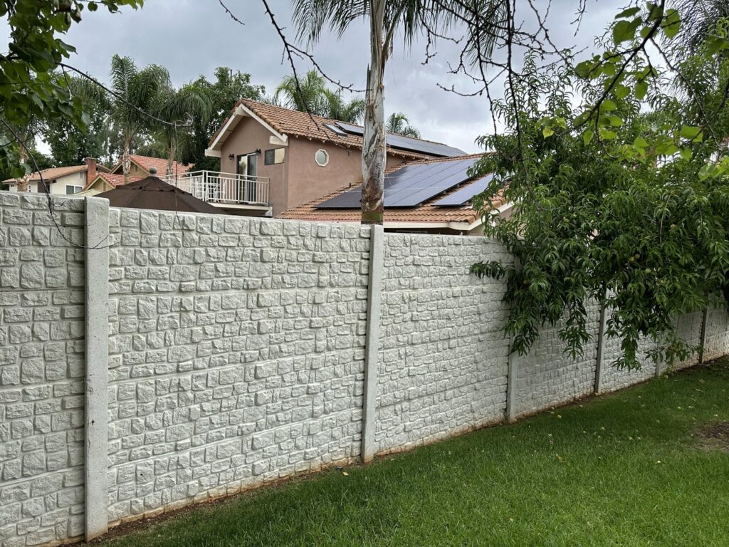 A white concrete fence with a small block texture pattern by StackWall Manufacturing in Pomona, CA.