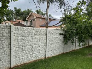 A white concrete fence with a small block texture pattern by StackWall Manufacturing in Pomona, CA.