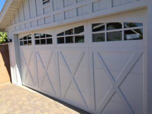 A white carriage house style garage door with X-bracing and windows installed by Stapley Action Garage Door in Mesa, AZ.