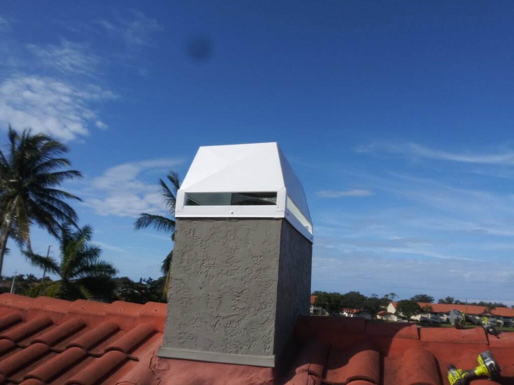 A white chimney cap installed on a tiled roof by SWFL Chimney Caps Inc. in Fort Myers, FL.