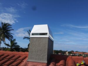 A white chimney cap installed on a tiled roof by SWFL Chimney Caps Inc. in Fort Myers, FL.