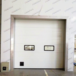 A white commercial sectional garage door with two windows installed by Hines Garage Doors Service & Repair in Seattle, WA.