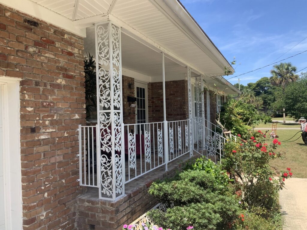 White decorative metal railings installed on a porch by Ability Burglar Bars in Jacksonville, FL.