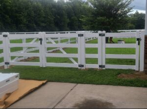 A newly installed white farm-style fence with wire mesh and gates by Fast Fence LLC in Bradenton, FL.