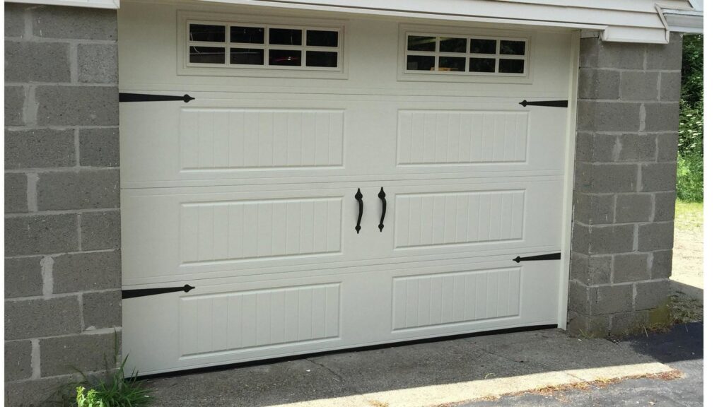 A white garage door with decorative hardware and top windows installed by Snowbird Garage Doors Company in Worcester, MA.