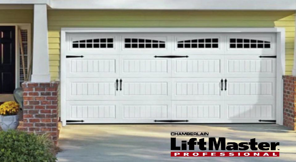 A newly installed white garage door with decorative windows and hardware by Garage Doors & Remodeling LLC in Blue Springs, MO