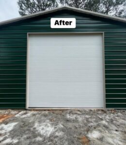 A newly installed white garage door on a green metal building, showcasing a completed job by Geaux Overhead Door in West Monroe, LA.