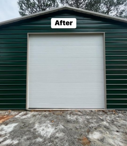 A newly installed white garage door on a green metal building, showcasing a completed job by Geaux Overhead Door in West Monroe, LA.