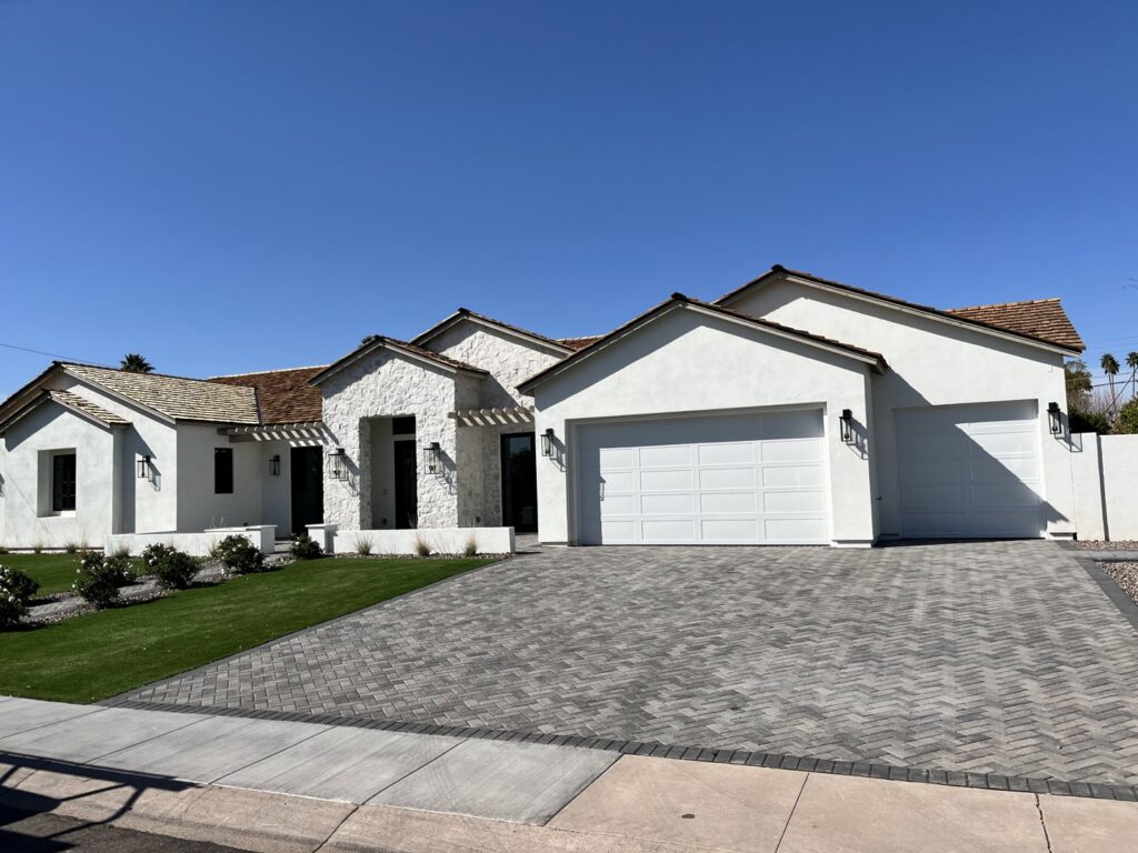 A white garage door installed on a modern home by Anew Garage by Jon's Garages in Surprise, AZ.