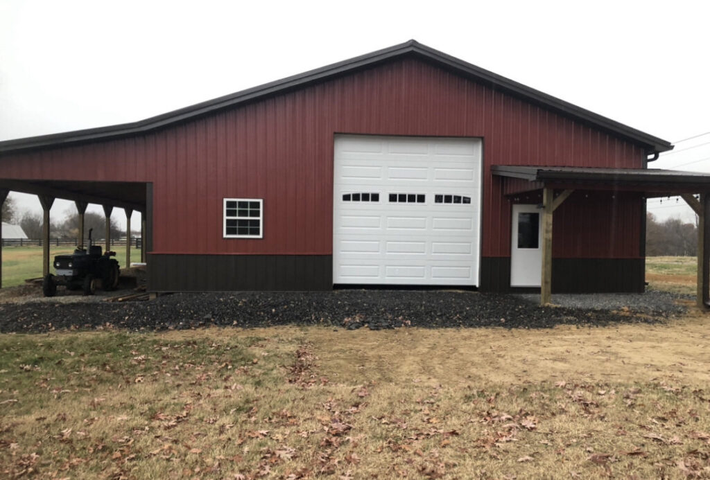 A white panel garage door installed on a red barn-style building by Smith's Garage Door in Clarksville, TN.