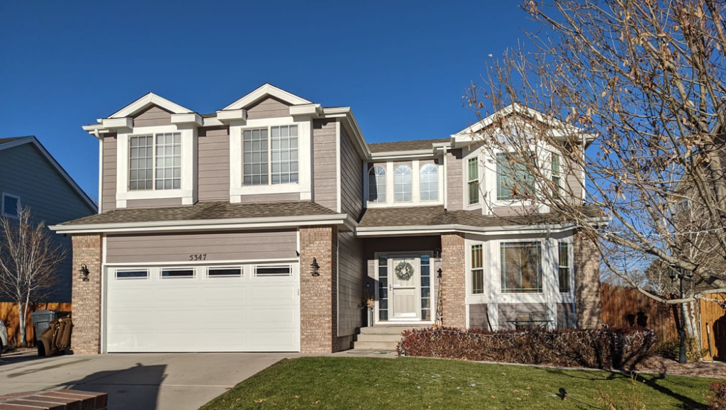 White garage door with horizontal windows installed on a home by Southern Colorado Garage Door in Pueblo, CO.