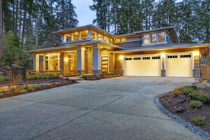 Two white garage doors with top windows installed on a modern house by Access Garage Doors-Chattanooga, TN