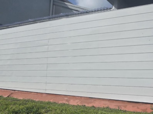 A clean white horizontal slat privacy fence installed by HD Multi Service USA INC, enhancing a property in Miami, FL.