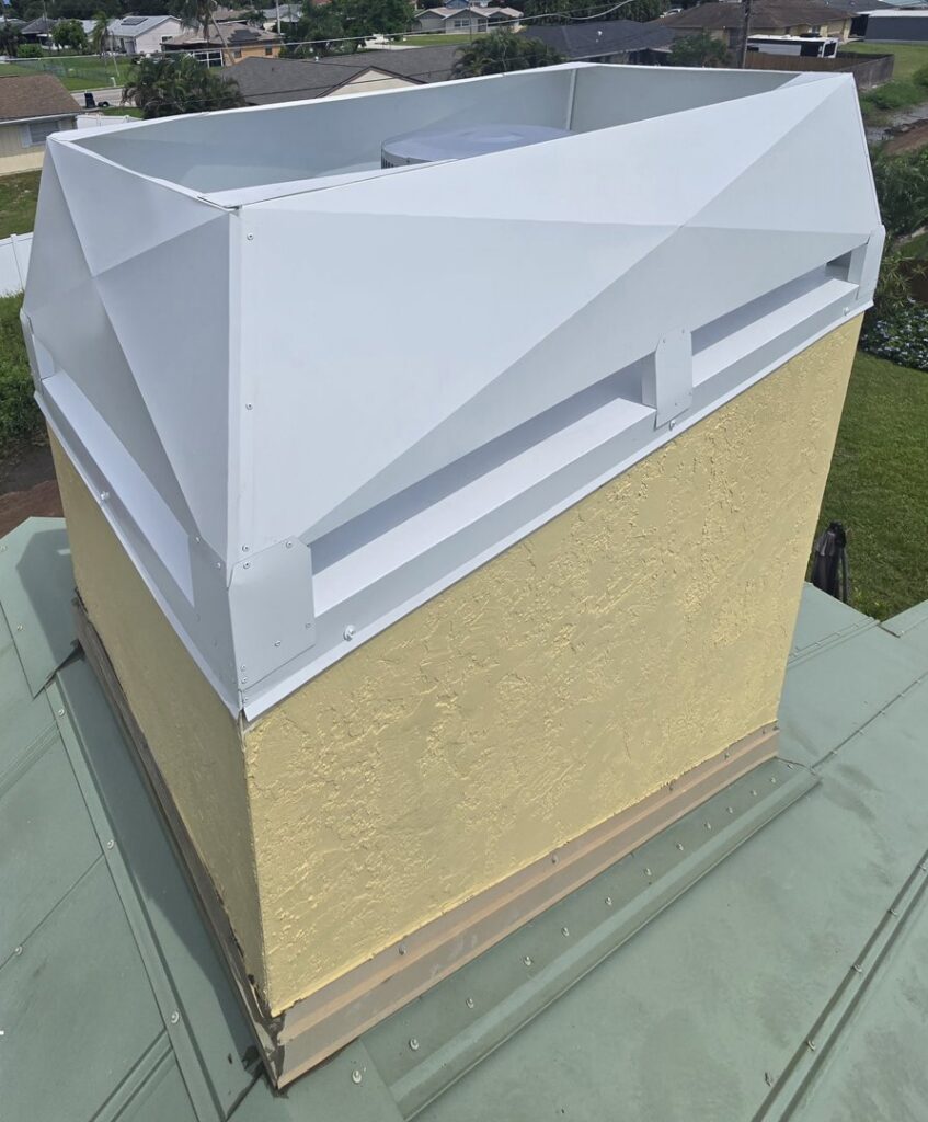 A white modern chimney cap installed on a yellow stucco chimney by SWFL Chimney Caps Inc. in Fort Myers, FL.