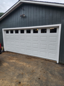 A classic white panel garage door with windows, expertly installed by Reed's Garage Door Systems LLC in Sutherlin, OR.