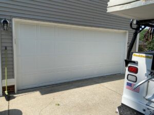 A white panel garage door installed on a residential home by Smith's Garage Door in Clarksville, TN.