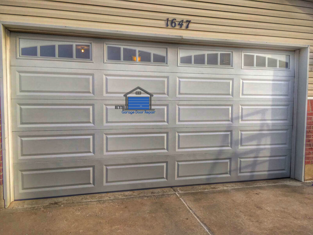 A white panel garage door with decorative windows installed by ETS - Garage Door & Electric Gate Repair Of Bellevue, WA.