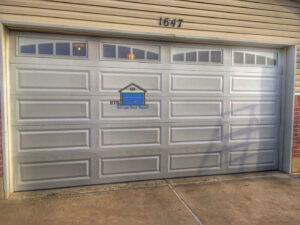 A white panel garage door with decorative windows installed by ETS - Garage Door & Electric Gate Repair Of Bellevue, WA.