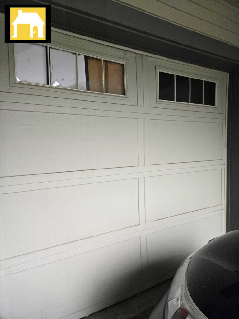 White panel garage door with decorative windows, installed or serviced by TH Locksmith And Garage Door Repair, Vancouver, WA.