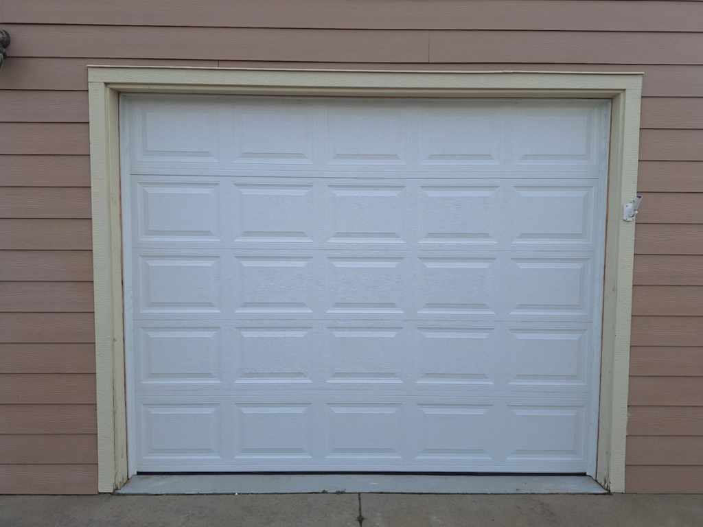 A classic white panel residential garage door installed by Roll-Rite Garage Doors in Denver, CO.