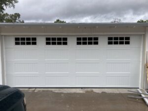 A newly installed white paneled garage door with top windows by Anew Garage by Jon's Garages in Surprise, AZ.