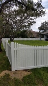 A classic white picket fence installed around a residential backyard by Aarons fence in Homosassa Springs, FL