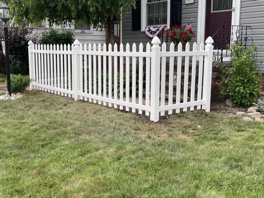 A charming white picket fence installed in a front yard by Affordable Fencing in Parma, OH.
