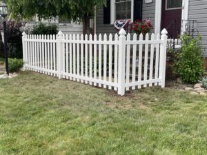 A charming white picket fence installed in a front yard by Affordable Fencing in Parma, OH.