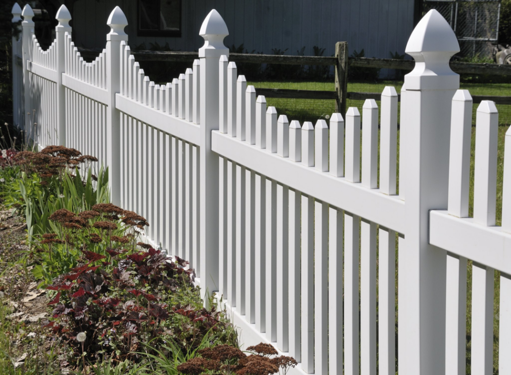 A newly installed white picket fence with decorative finials by Metrofence in Grand Rapids, MI.