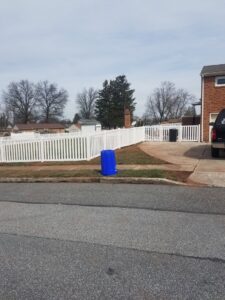 A white picket-style fence installed along a residential street by DZS Fencing, LLC in Red Lion, PA.