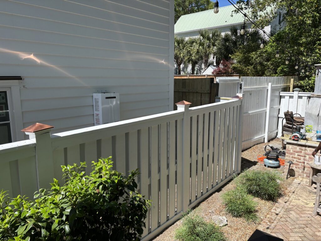 A white picket-style privacy fence with decorative post caps, installed by True Line Fencing LLC in Mount Pleasant, SC.