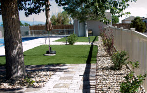 A white aluminum fence installed around a pool area by Fence Tech in Everett, WA, for safety and style.