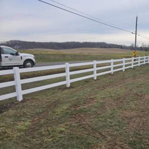 A long white post-and-rail fence installed by Meyers Fence Company alongside a road in Kent, OH