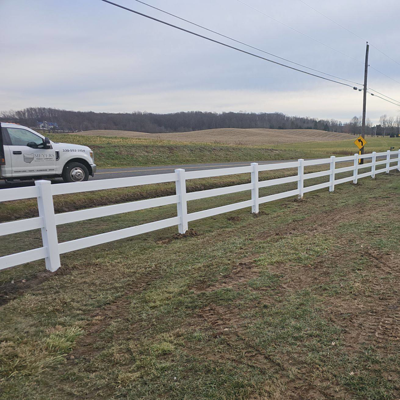A long white post-and-rail fence installed by Meyers Fence Company alongside a road in Kent, OH