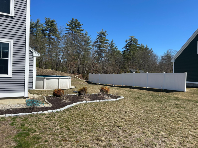A white privacy vinyl fence installed around a backyard pool area by Vinyl Fences Inc. in Dover, NH.
