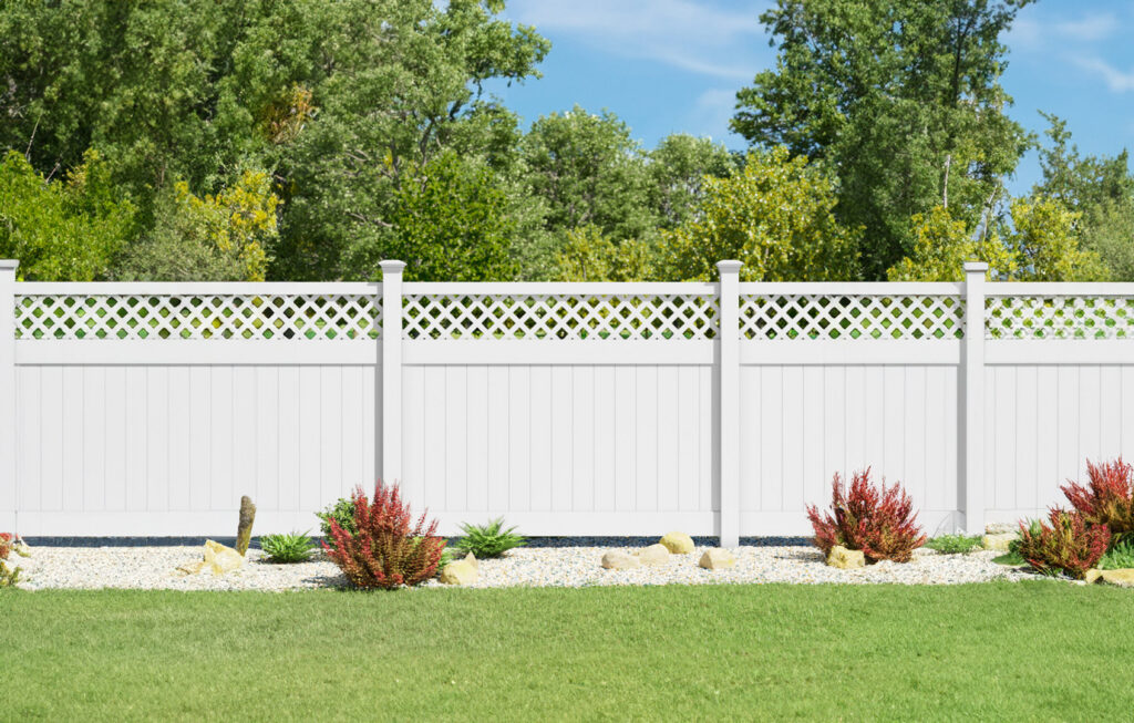 A beautiful white PVC fence with a decorative lattice top installed in a residential yard by MY PVC Fences in Miami, FL.