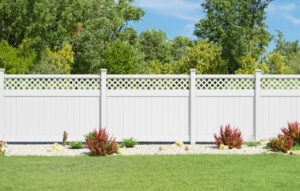 A beautiful white PVC fence with a decorative lattice top installed in a residential yard by MY PVC Fences in Miami, FL.