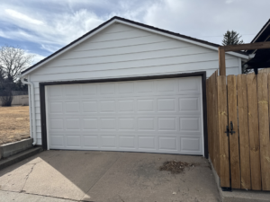A modern white residential garage door installed by Usa Garage Door Services and Construction, LLC at 1206 E 6th St, USA.