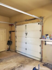 An interior view of a white sectional garage door, installed or serviced by Black Forest Door Repair in Colorado Springs, CO.