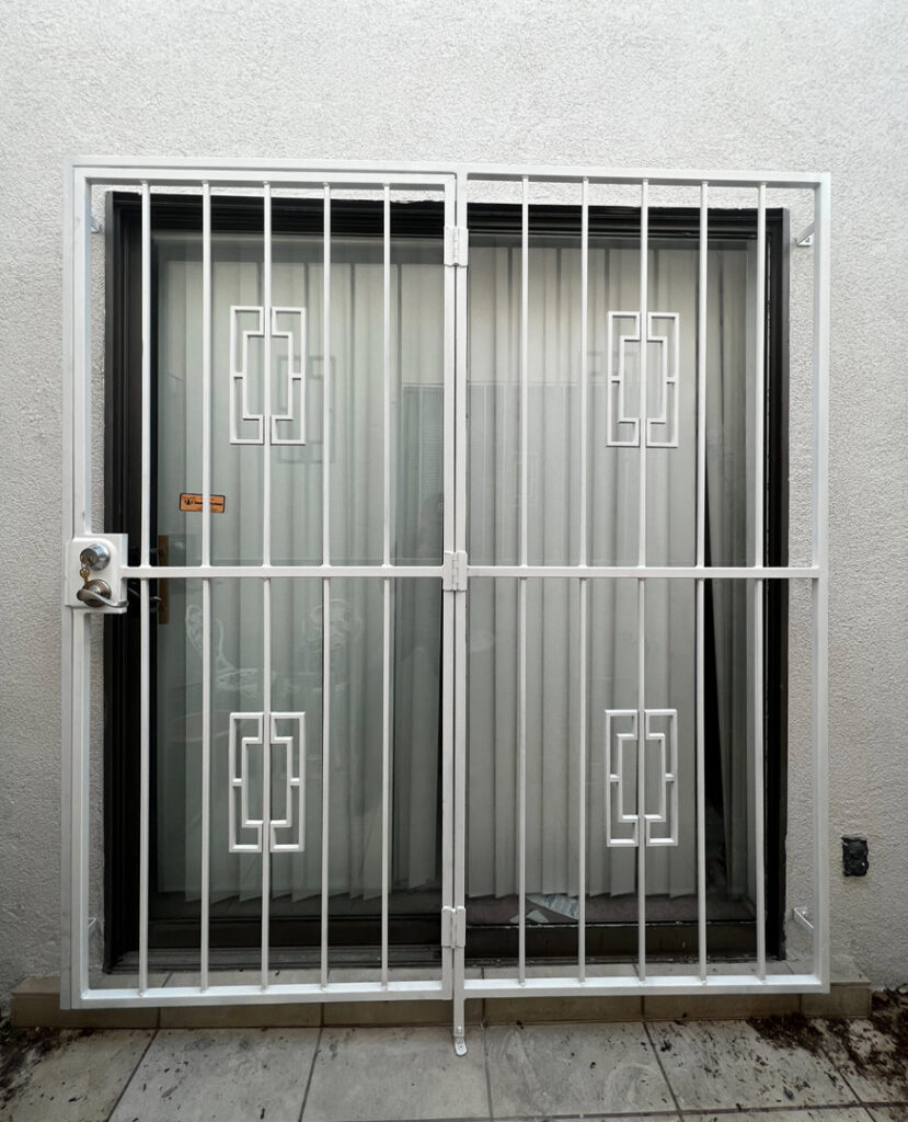 White security bars with geometric patterns installed on a sliding glass door by City Iron LLC in Albuquerque, NM.