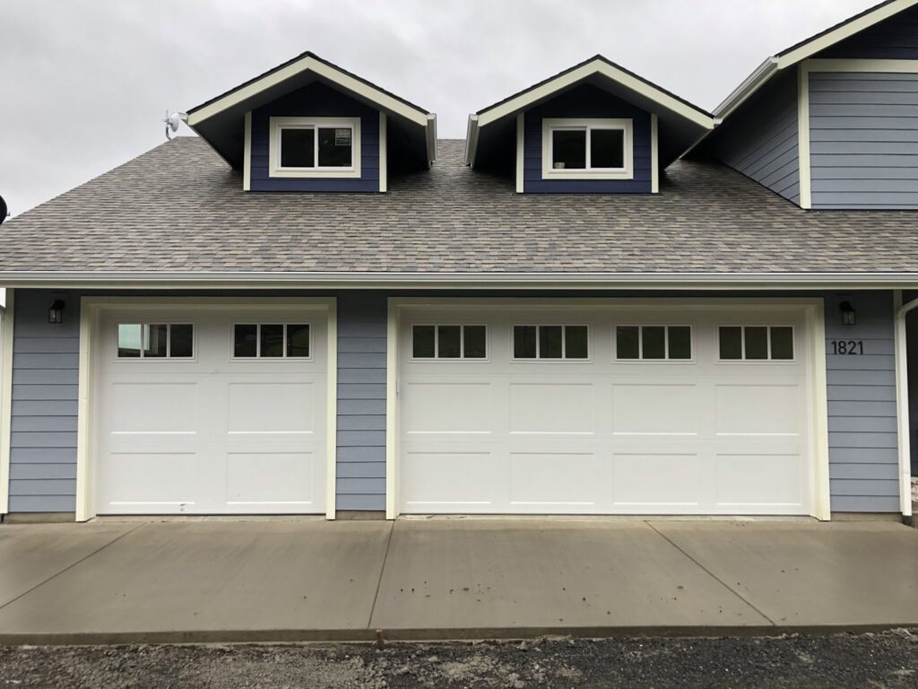 Two white traditional style garage doors installed by Revolution Garage Door, LLC in Corvallis, OR.
