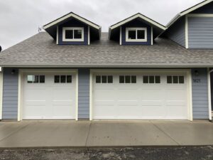 Two white traditional style garage doors installed by Revolution Garage Door, LLC in Corvallis, OR.