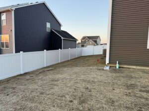 A white vinyl fence installed around a residential backyard by Fence Connection, Inc. in Elgin, IL.