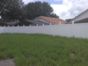 A white vinyl privacy fence installed in a residential backyard by Goldstar Fencing in Mascotte, FL.