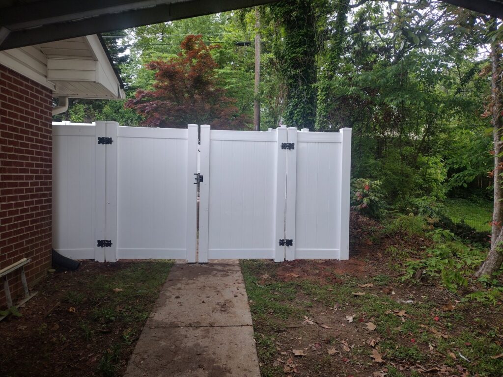 A white vinyl fence with a double gate installed by Fantastic Fences in Chattanooga, TN