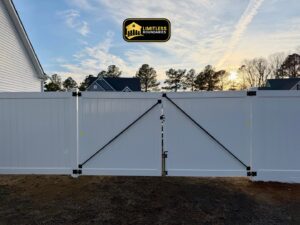 A newly installed white vinyl fence featuring a double gate, completed by Limitless Boundaries LLC in Garner, NC.